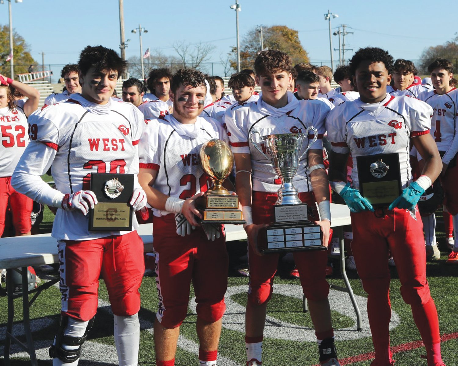 TURKEY DAY WIN: Cranston West’s Steven Girouard, Dimitri LeBlanc, Domenic Schiavulli and Marcus Chung show off the post-game awards that were handed out on Thanksgiving .